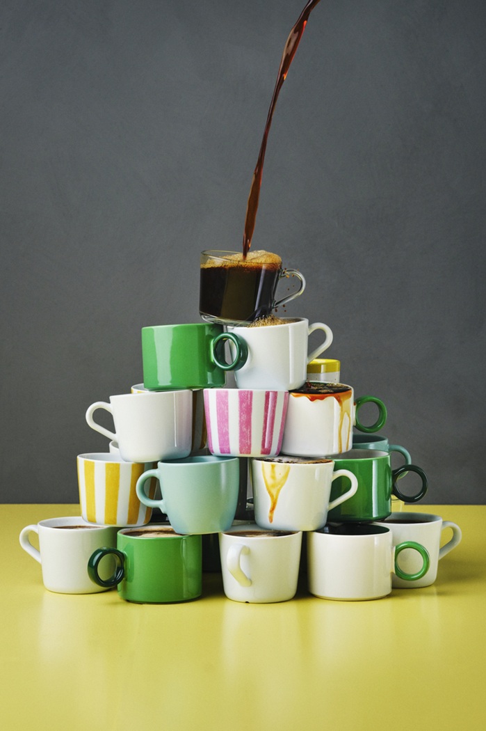 Stacked mugs in assorted colours and styles, forming a playful pyramid.