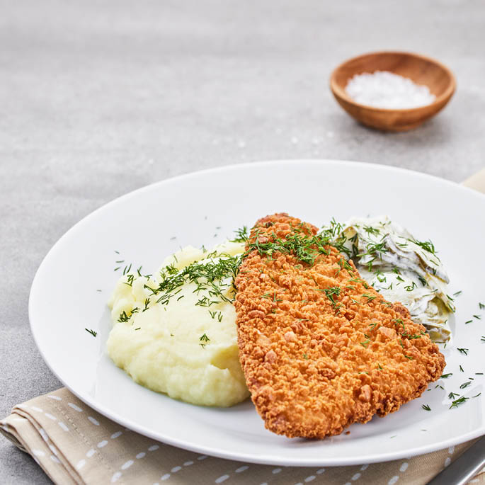 Dish at the Swedish Restaurant: cod in breadcrumbs with a side dish of vegetables and grains, along with white wine sauce