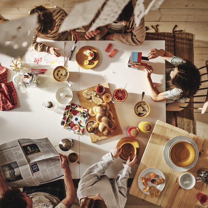 Family enjoying breakfast together at a bright dining table.