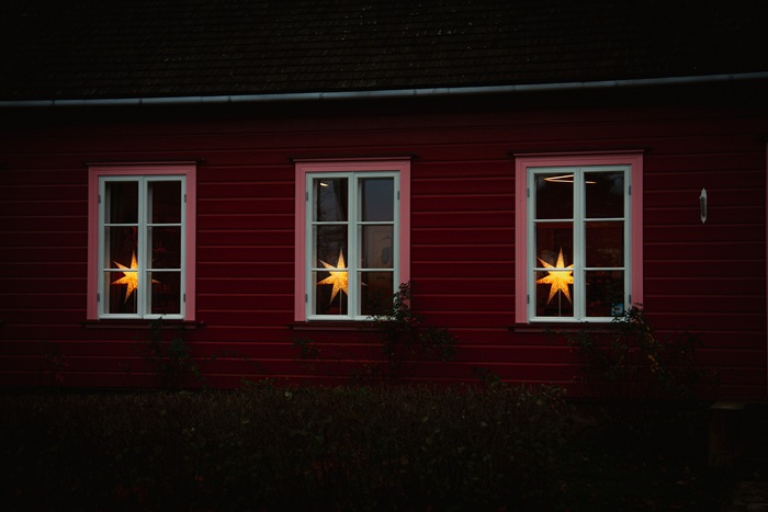 An exterior view of the three windows of the Kihnu Museum. STRÅLA stars shine on the windowsills.