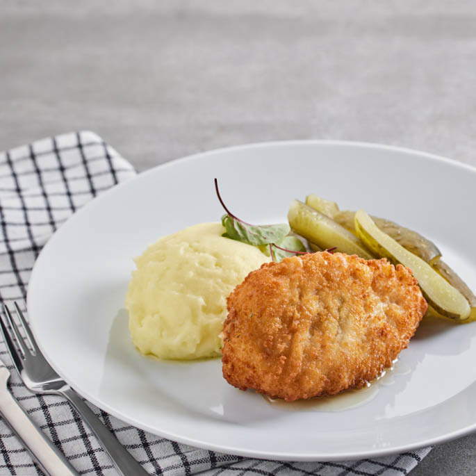 Dish at the Swedish Restaurant: cod fillet in batter with French fries, cucumbers, mayonnaise, barbecue sauce, fresh dill and cucumber-mustard salad