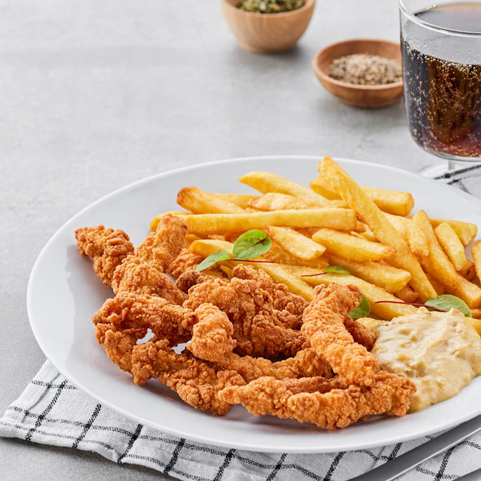 Dish at the Swedish Restaurant: cod fillet in batter with French fries, cucumbers, mayonnaise, barbecue sauce, fresh dill and cucumber-mustard salad