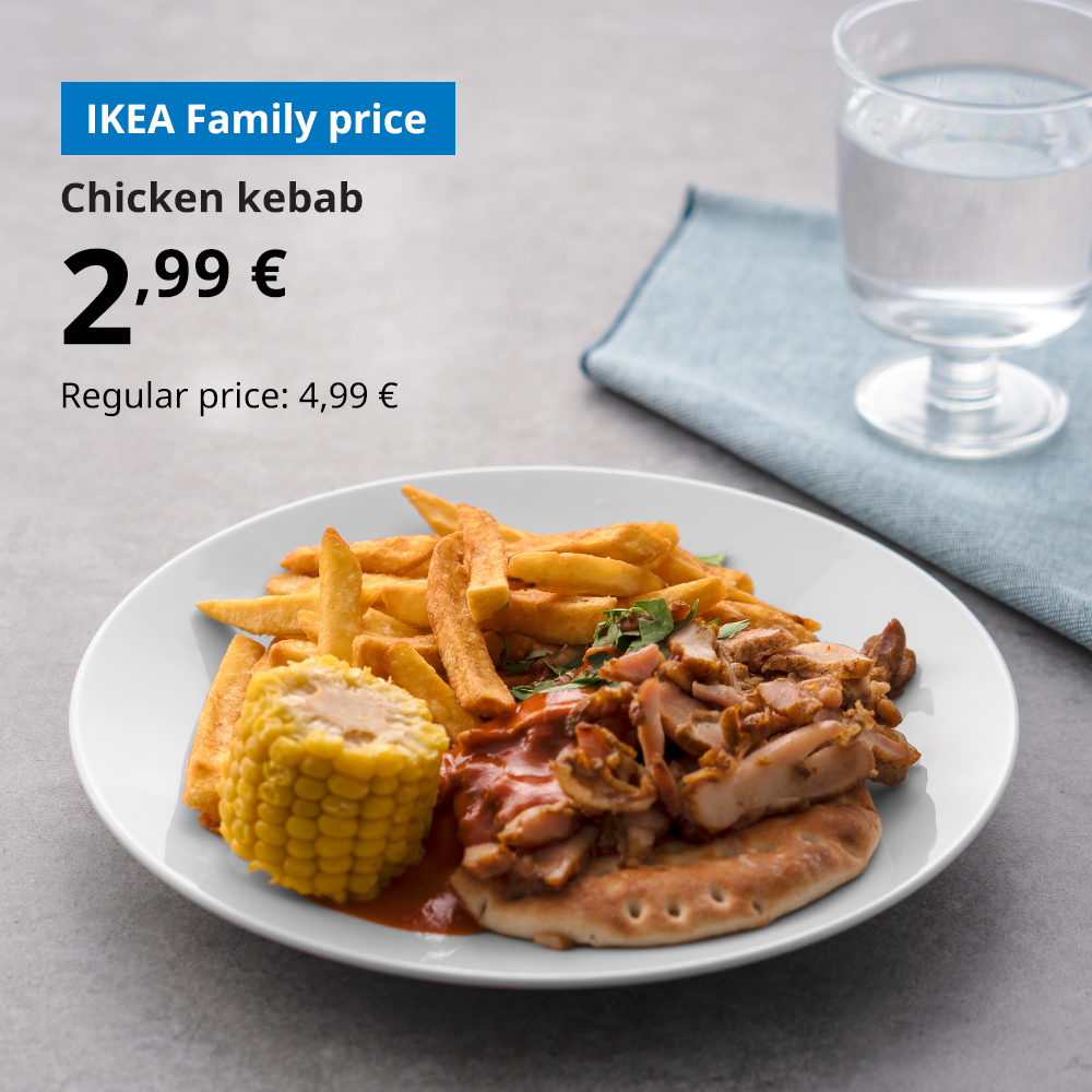 Chicken kebab on a white plate with polar bread, french fries, corn and tomato sauce.