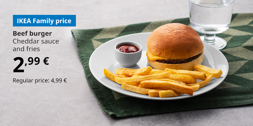 A beef burger with fries and a bowl of ketchup on a white plate, with a glass of water next to it. The blue box has white text: Beef burger, Cheddar sauce and fries. 2.99 euros. Regular price 4.99.