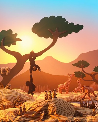A sunlit savannah made from cardboard cutouts and duvet covers and pillowcases is filled with SANDLÖPARE soft toy animals.