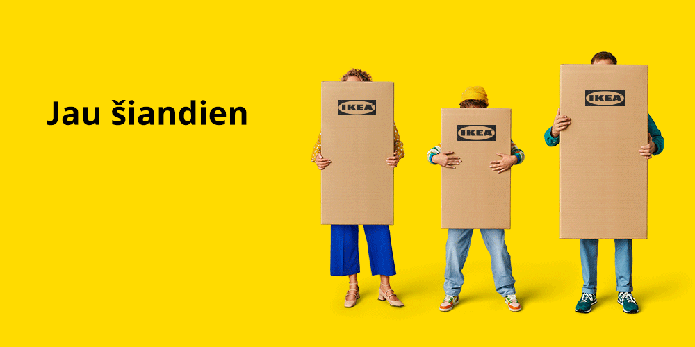 Trys žmonės stovi geltoname fone ir kiekvienas laiko rankose po kartoninę IKEA prekių dėžę.